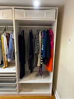 Full view of IKEA Pax wardrobe section with storage box and hanging rod