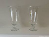Pair of clear blown glass vases side by side
