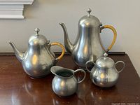Full set of four Royal Holland pewter pieces on table