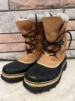 Front three-quarter view of both boots showing uppers and soles