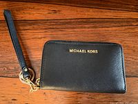 Front view showing Michael Kors logo and wrist strap