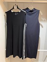 Both dresses front & back on hangers