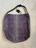 front view of purple suede tote showing overall shape and pattern