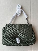 Front view showing flap, quilting, hardware and protective wrap