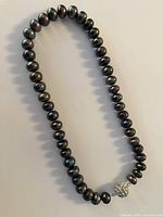 Full view of entire pearl strand showing clasp placement