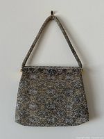 Full front view of beaded handbag with strap