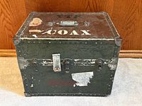 Front and side view showing latches, metal trim, stencils