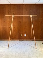 Full front view of wooden clothing rack set up