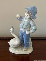 Full view of figurine showing boy and duck
