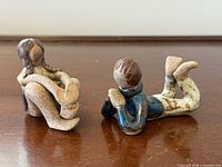 Both Cardi stoneware figurines, boy & girl, overall view