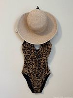 Hat and swimsuit hanging together