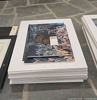 Stack of foam-core-mounted photos, top shows coral reef scene