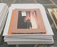 Stack of mounted photographs on foam core
