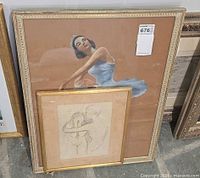 Both artworks leaning upright to show relative sizes and frames