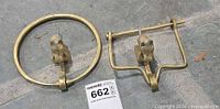 Both brass horse head door knockers, circular and square styles, lot tag visible