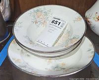 Two nested floral enamelware bowls showing pattern and rims