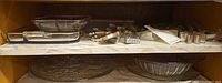 Shelves with glass serving pieces and cookie cutters