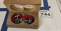 Open wooden box showing cufflinks and studs