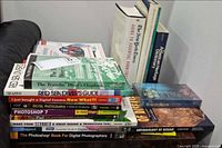 Overall view of stacked books on couch and side table