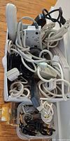 Overview of box filled with surge protectors, cords, timer