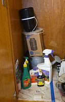 Overall view showing mosquito trap, boxed trap, watering can and garden chemical bottles