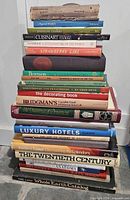 Full stack of hardcover and paperback books, spines visible