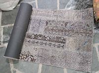 Runner partially unrolled showing overall patchwork design and edge binding