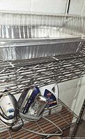 Nested aluminum pans on wire shelf
