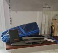 Group overview showing acrylic stand, blue jewelry roll, wallet and pouches