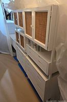 Full view of white Kopenhavn storage unit showing cabinet doors, open shelf, and drawers