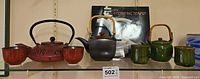 Overview of three teapots, four cups, signed book