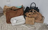 Group shot of six leather handbags