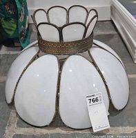 Side view of complete white slag glass tulip lamp shade with brass frame