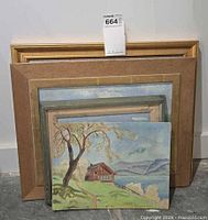 Stack of four framed artworks front showing farmhouse painting