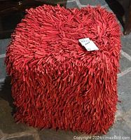 Full view of red shag pouf ottoman