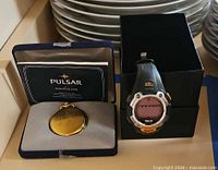 Pulsar pocket watch in box alongside Timex Ironman watch