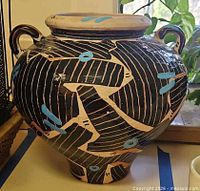 Front view of signed hand-painted terracotta vase showing abstract design and handles