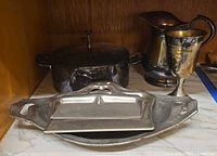 Group view showing casserole, crumb tray with lid, pitcher, goblet
