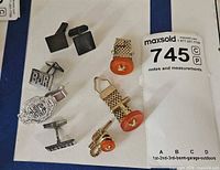 All cufflinks and tie clip arranged together