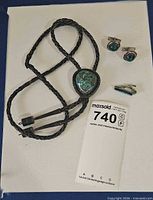 Full lot showing bolo tie, cufflinks, tie clip