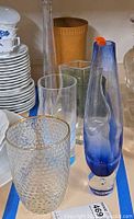 Group of assorted vases including hobnail, blue art glass, clear cylinder, Lilas bud vase and terracotta piece