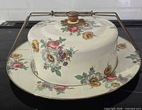 Top view of carrier showing floral dome, platter, metal handle and wood knob