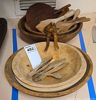 Stacked wooden bowls with utensils inside