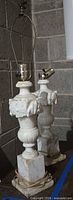 Two alabaster marble table lamps displayed on table showing full form and harps