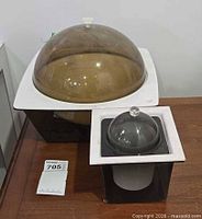 Large and small plastic ice buckets side by side showing size difference and overall design