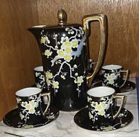 Full set showing chocolate pot with four cups and saucers