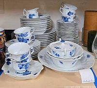 Stacks of plates, cups, saucers, serving pieces of Royal Copenhagen Blue Fluted Full Lace set on shelf