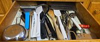 Drawer view showing entire assortment of utensils