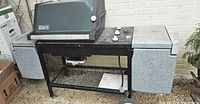 Full view of Weber grill showing lid, side tables, cart