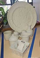 Group view of platter, stand, berry basket, creamer, sugar bowl, vase, shaving mug, shakers